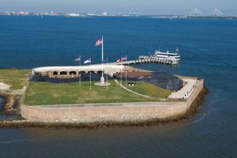 a large ship in a body of water with Fort Sumter in the background